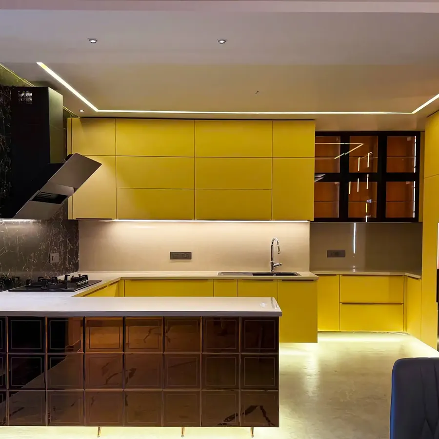 A yellow modular kitchen built by Kalky Interior