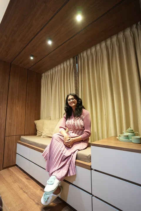 Kalky Interior designer at the Shillong studio, beside a backlit display unit