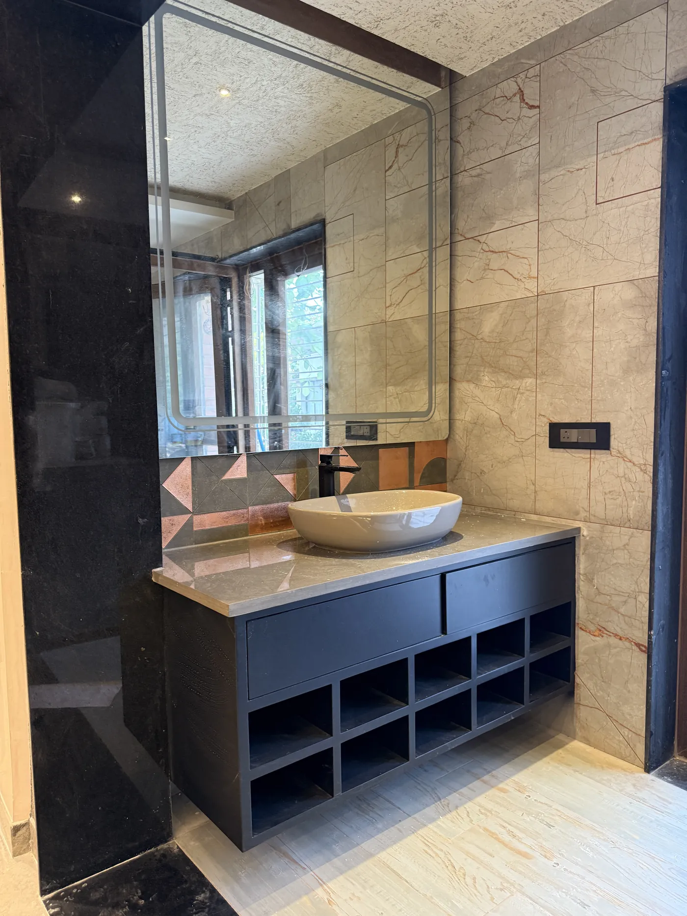 Bathroom vanity in dark laminate with open shelving and a vessel basin