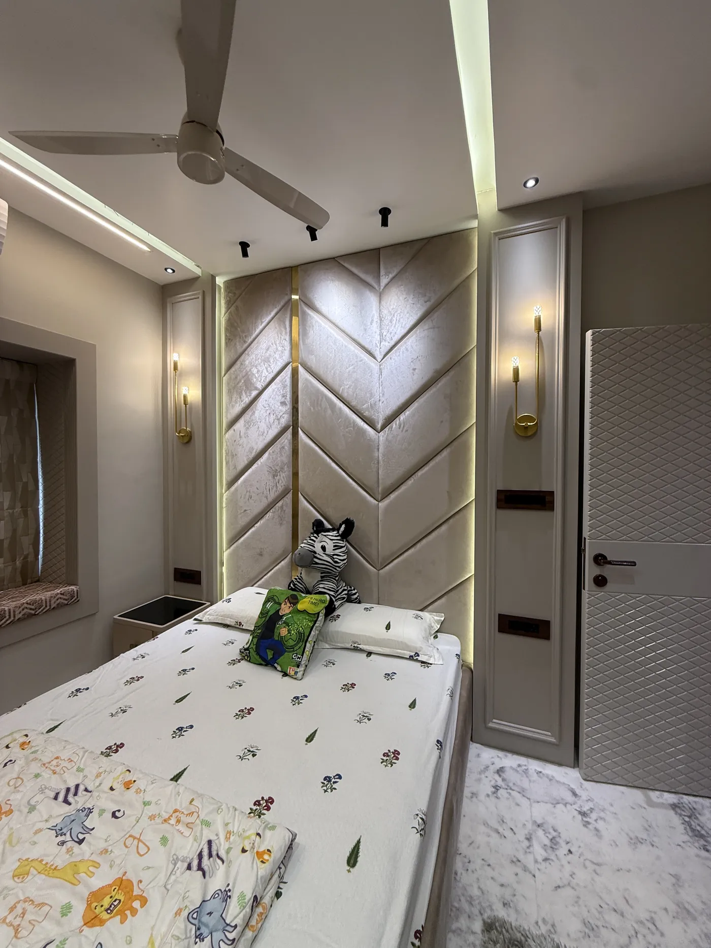 Bedroom with a chevron timber headboard panel and recessed lighting
