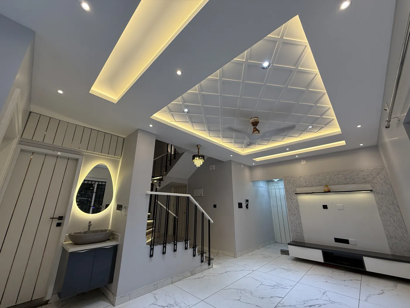 Hallway beneath a coffered false ceiling with concealed lighting