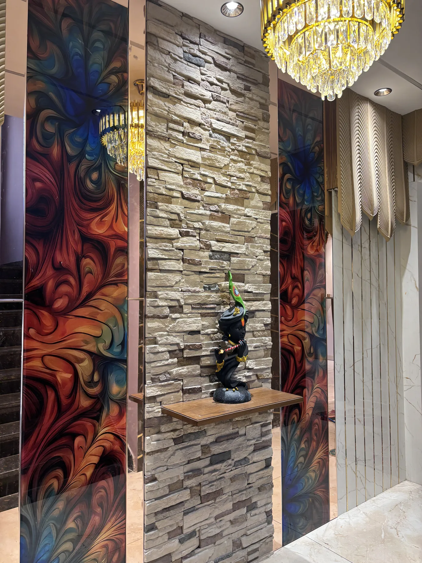 Entrance with stone cladding, a resin art panel and a display ledge