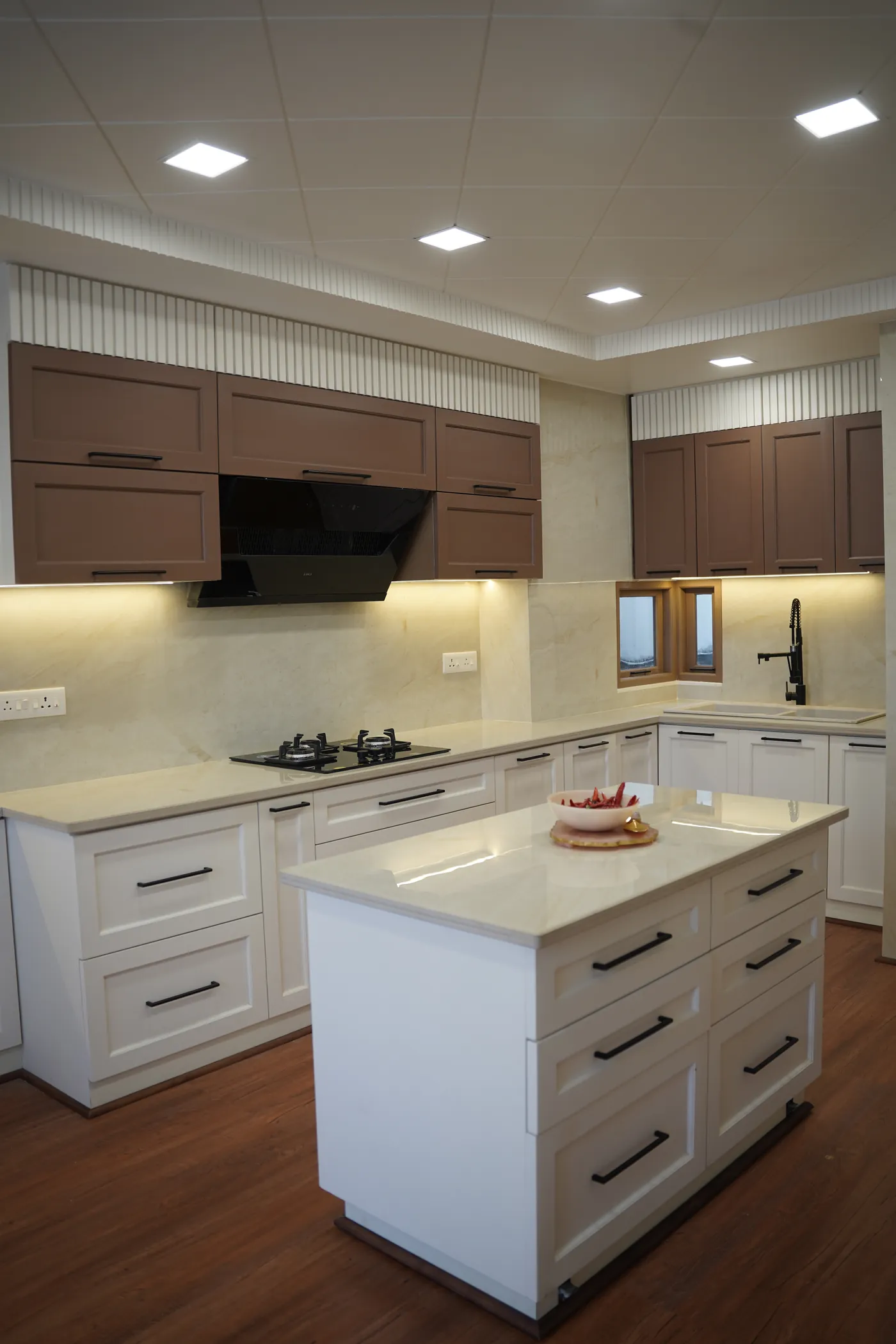 White kitchen island with drawer storage and a timber floor