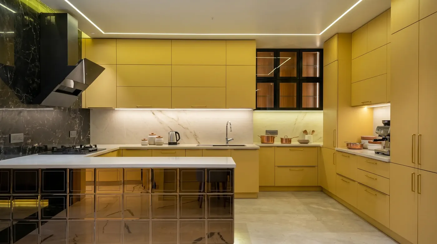 Yellow gloss modular kitchen with a marble island