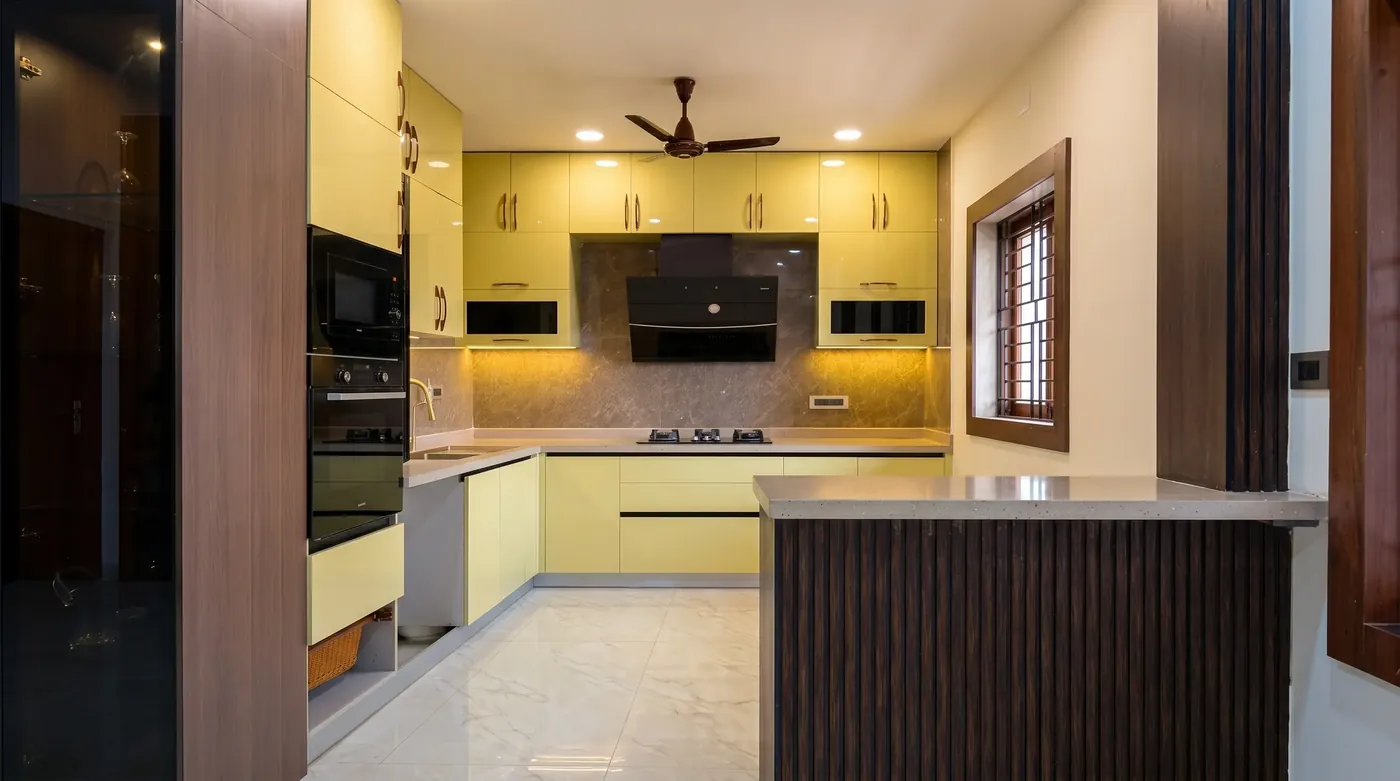 Pale yellow modular kitchen with a timber island and tall units