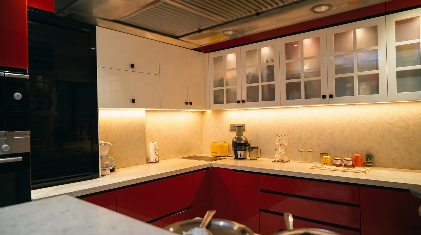 Red and cream modular kitchen with glazed wall cabinets