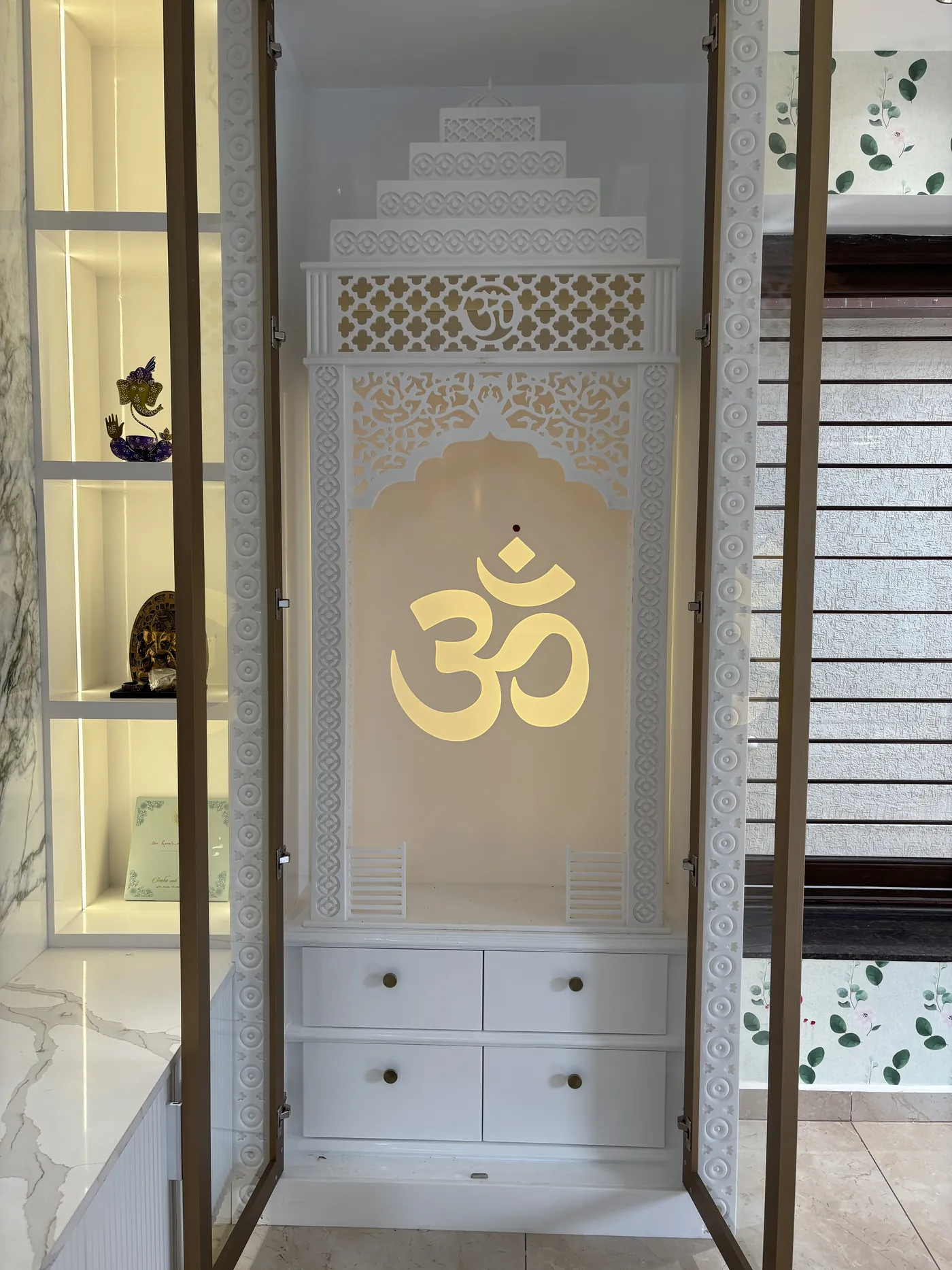 White puja mandir with a carved jali back panel and drawer storage