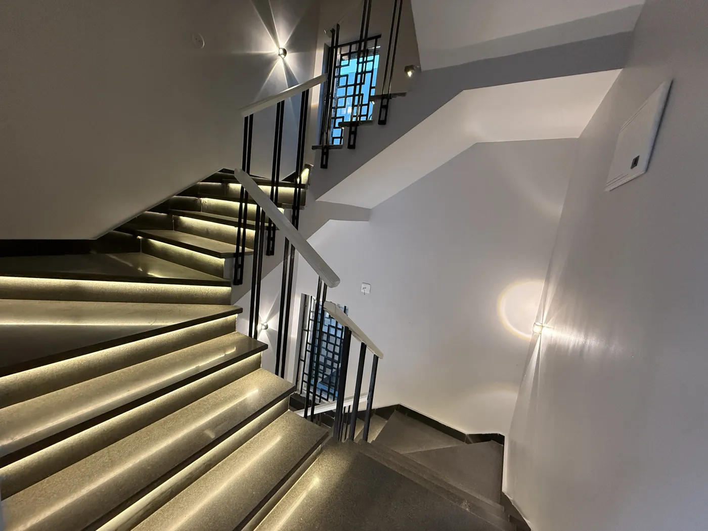 Staircase with concealed LED strip lighting along the treads